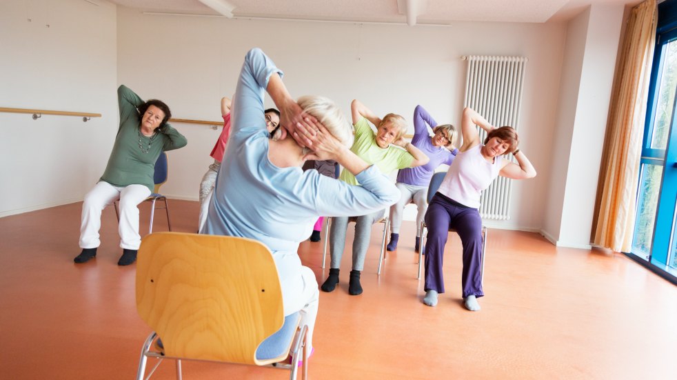 group doing chair stretches